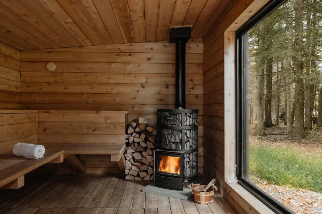 a wood burning stove inside of a wooden cabin