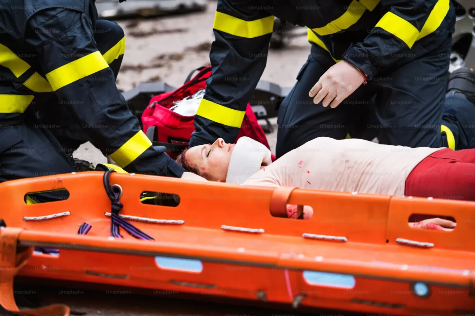 Essential Actions to Take Following an Injury firefighters helping injured women lying on the road