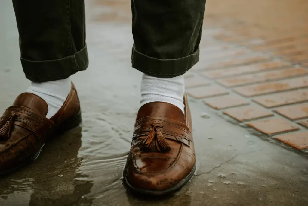 10 Expert Tips for Buying Durable Men's Leather Sandals person in brown leather shoes