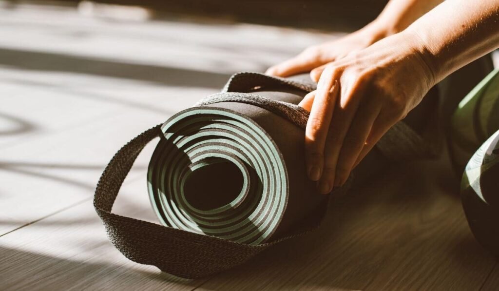 A person is folding yoga mat