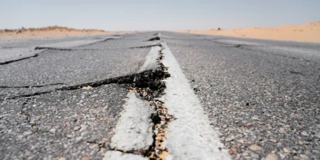 A giant crack in a road.