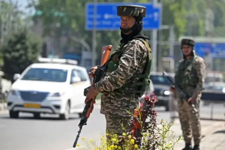 Indian paramilitary troopers stand guard.