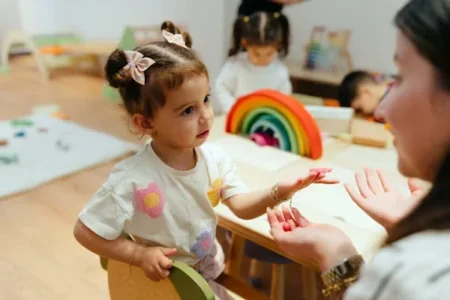 7 Tips to Evaluate the Best Child Care Campus Facility a woman talking to a kid
