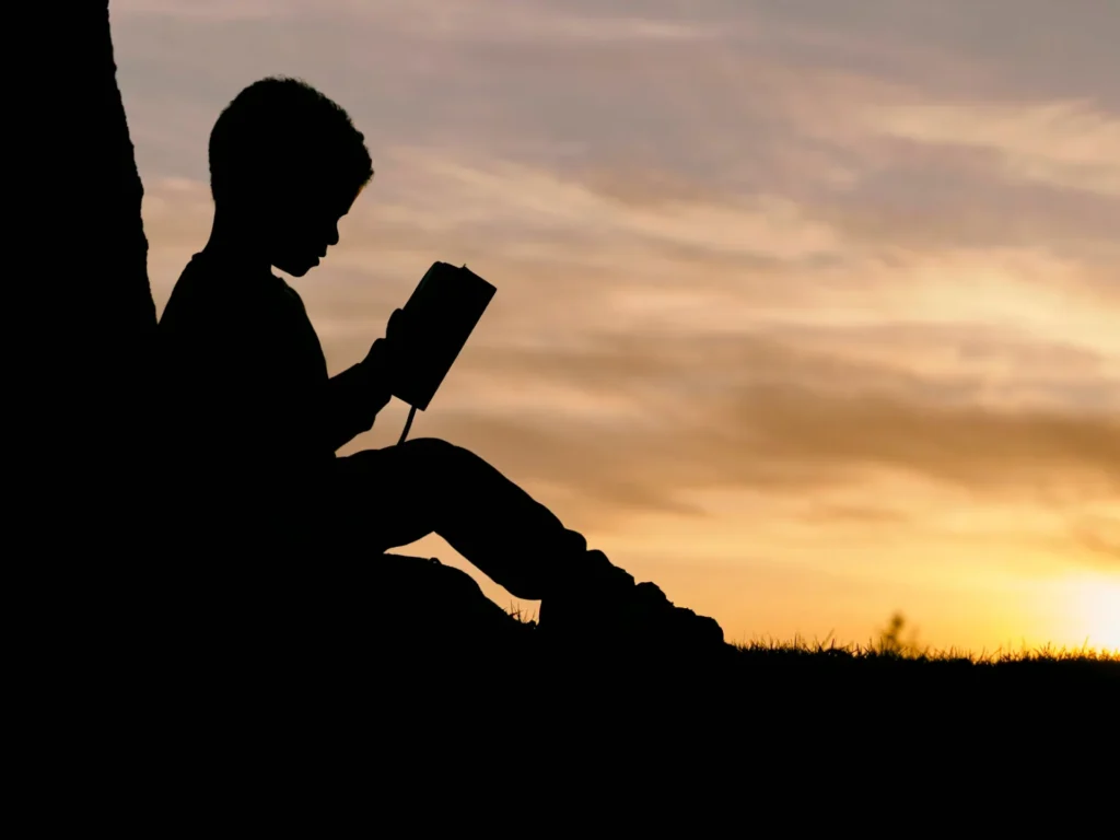 child sitting reading book