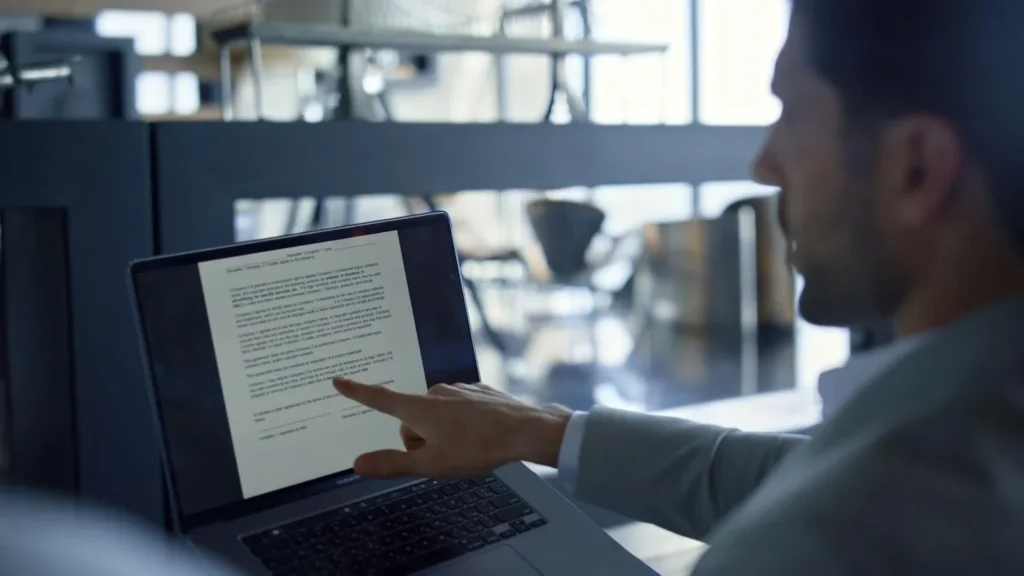 man is touching laptop screen