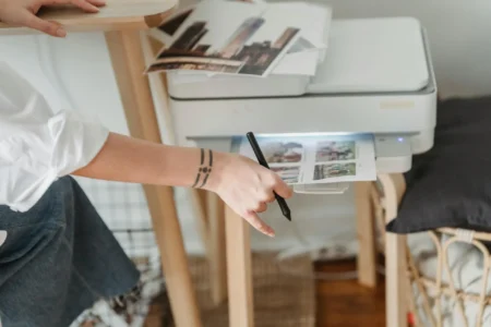 woman printing photos on paper