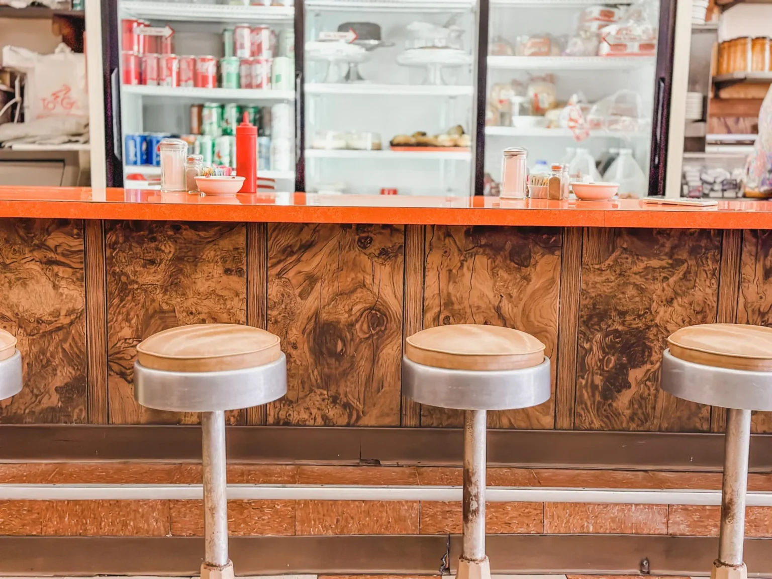 wooden stools in front of counter