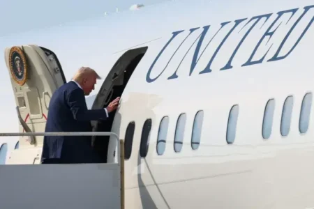 Trump Considers Accepting Qatar Jumbo Jet Gift for Interim Air Force One Donald Trump boarding a plane.