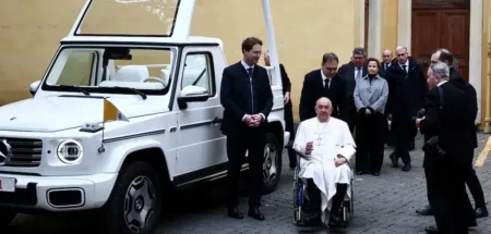 Pope next to the popemobile