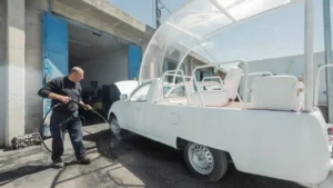 A man working on the popemobile.