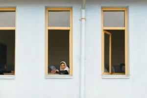 A woman staring out of a window.