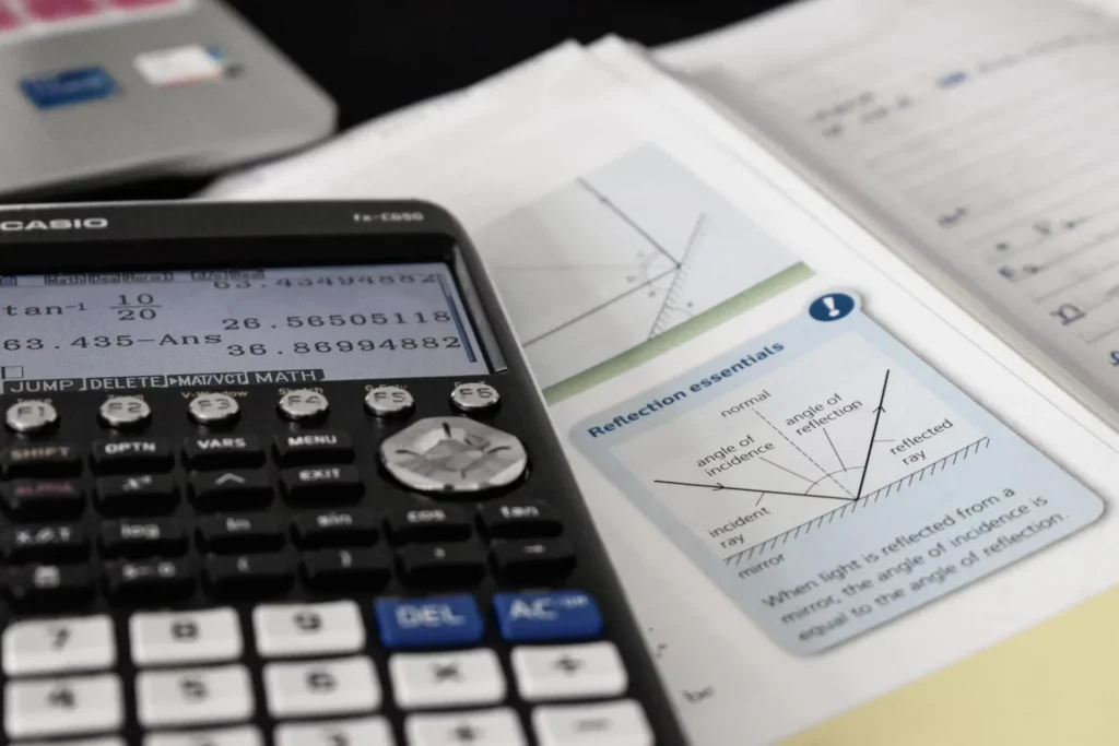 Tips for Parents Seeking a Qualified Physics Tutor Calculator on a book
