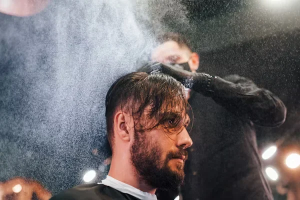 How to Apply Hair Pomades Correctly for a Perfect Look A man getting a hair cut