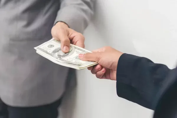 A man giving money to other person