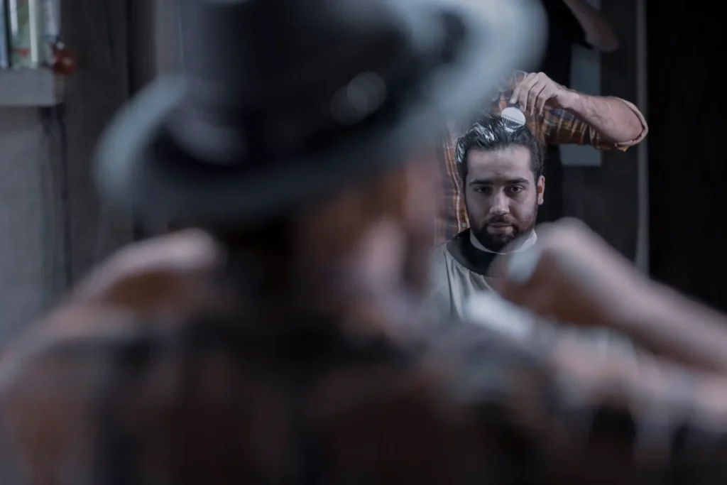 How to Apply Hair Pomades Correctly for a Perfect Look man looking in the mirror