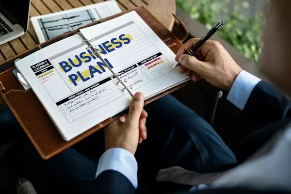 What Ambitious Founders Need to Future-Proof Their Vision a man writing business plan on his diary