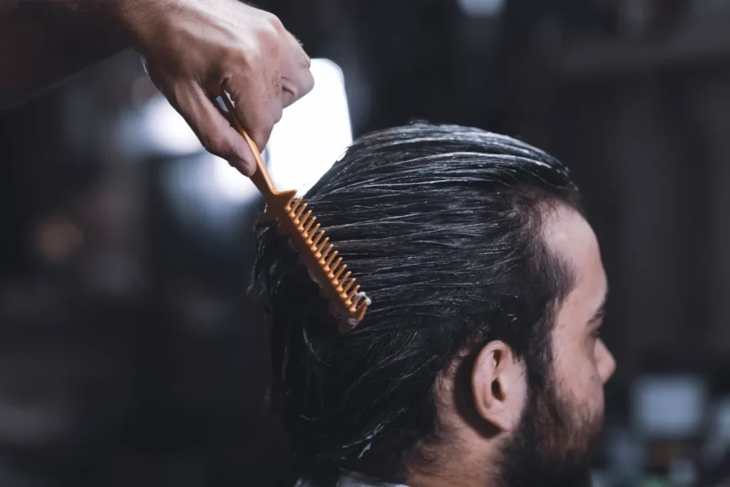 a person combing man's hair