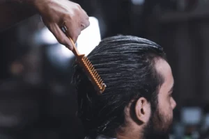 a person combing man's hair