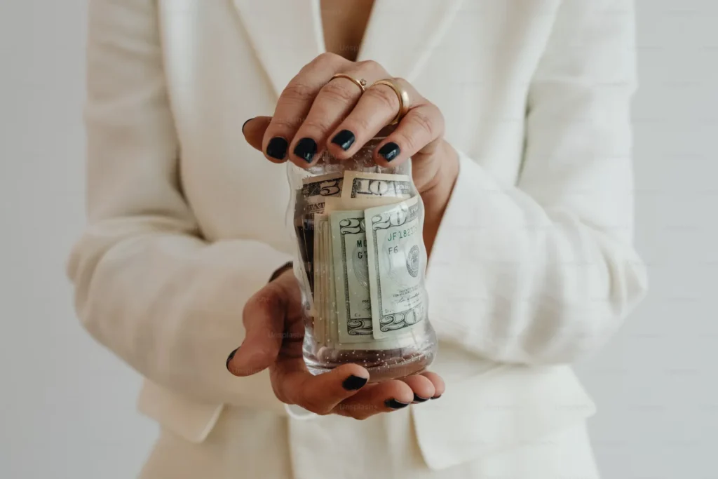woman holding a jar of money