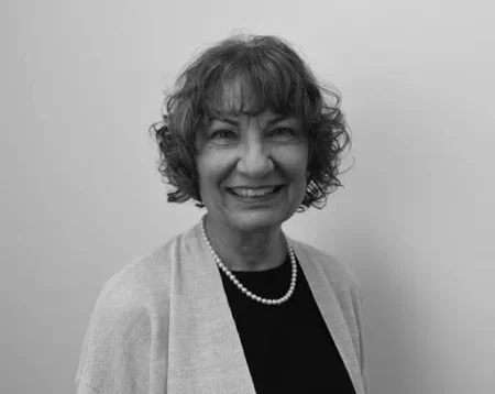 A woman smiling while taking a picture.