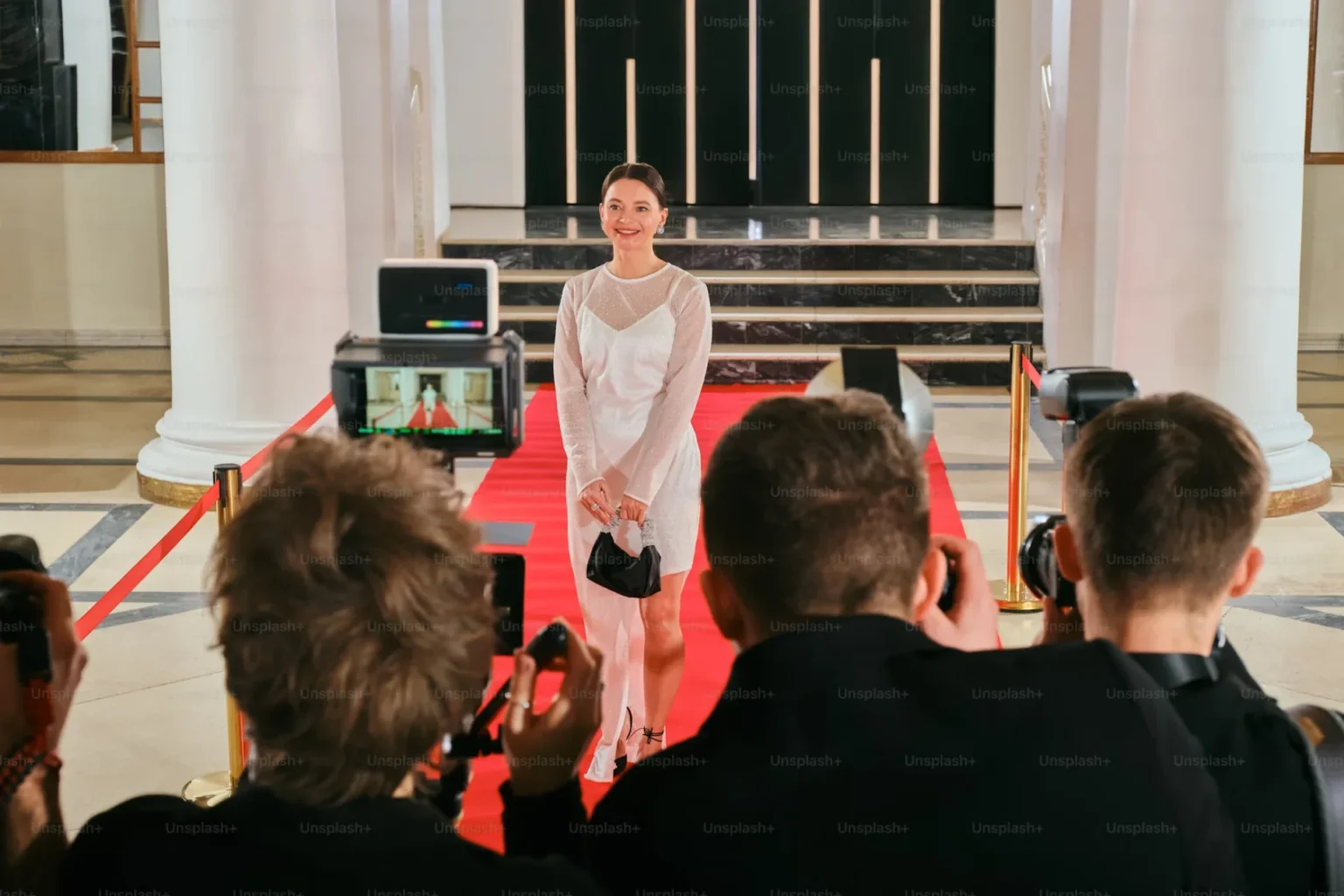 a woman walking down a red carpet