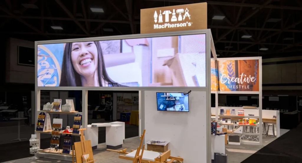 What Exactly Is an Exhibition Stand and Why Does My Brand Need One? a women smilling on screen 1