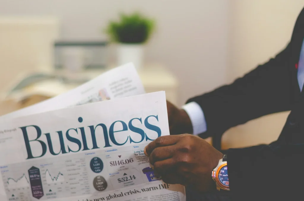 What Ambitious Founders Need to Future-Proof Their Vision a person holding newspaper