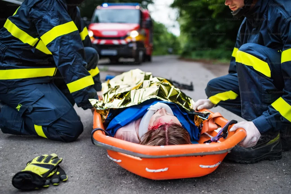The Process of Obtaining Workers' Compensation Benefits injured woman laying in plastic stretcher