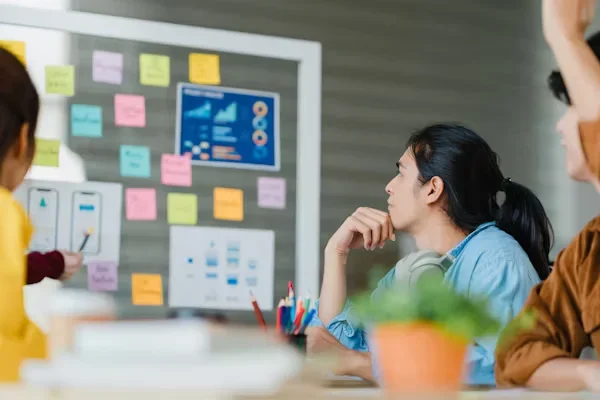 7 Benefits Business Coach Sessions Bring to New Startups a woman looking at a presentation board