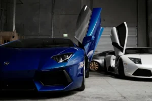 Two white and white cars in garage