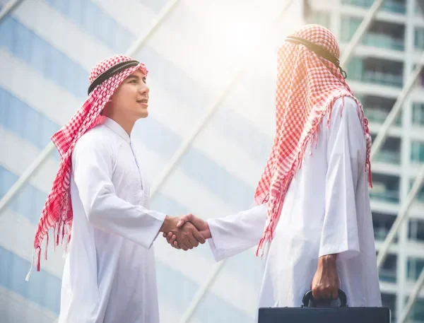 Respect, Rights & Risks: A Cautious Guide to Visiting the UAE Two men are shaking hands