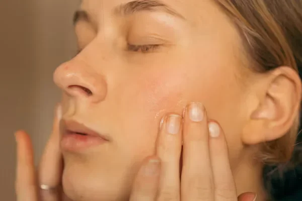 5 Best Tips for Buying the Right Liquid Foundation Woman touching her face with fingers