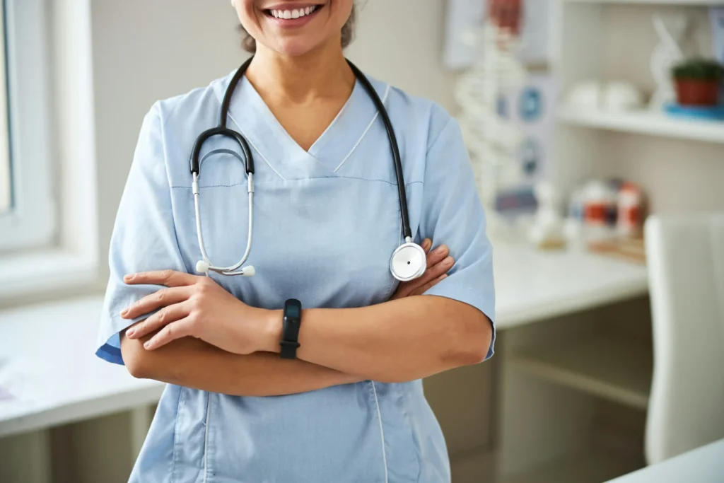 A woman wearing stethoscope around her neck smiling