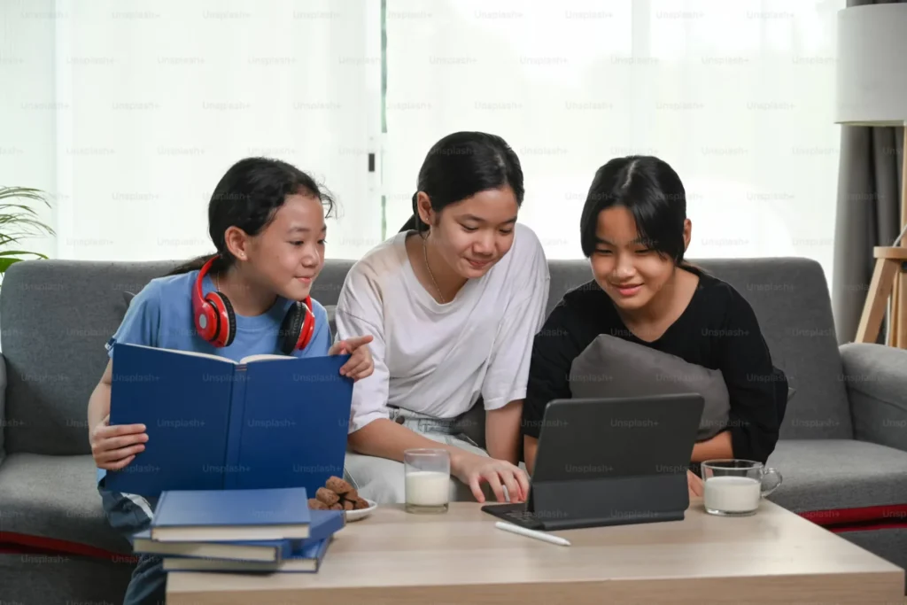 Study Smarter While Studying Abroad: Tools Every International Student Needs Girls sitting on couch