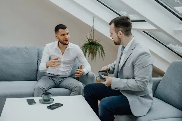 Proven Strategies to Master Business and Company Debt Negotiation Two men are taalking to each other