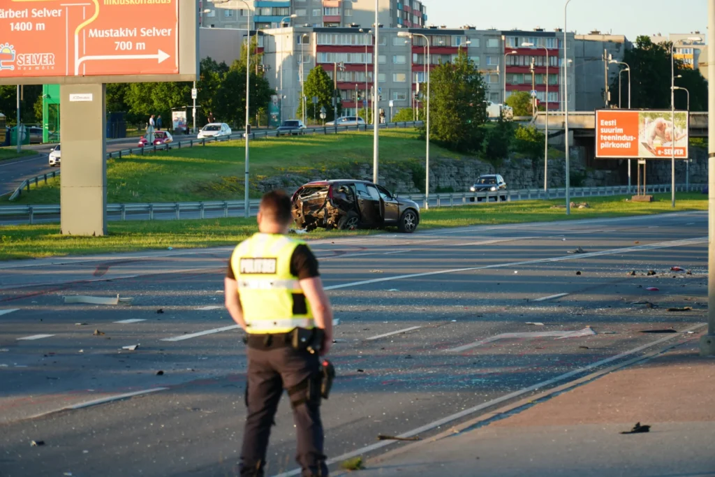 police officer standing besides a car
