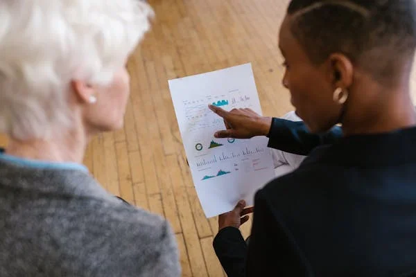 How Can Businesses Stay Ahead in Lead Gen Without Burning Out? woman pointing finger toward paper