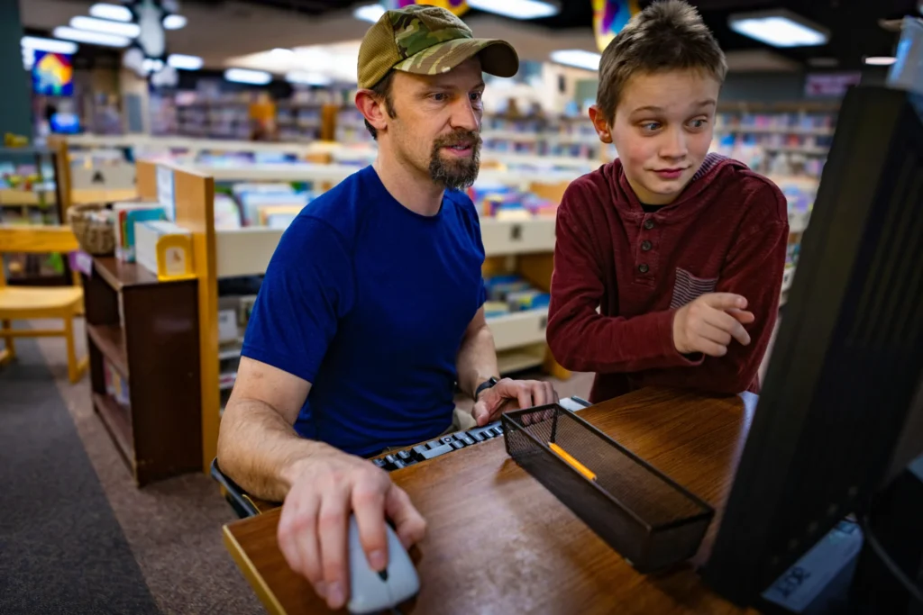 Man and boy using computer