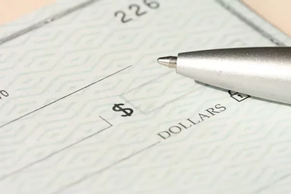 Proven Strategies to Master Business and Company Debt Negotiation a pen on a check