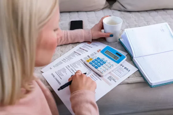 Proven Strategies to Master Business and Company Debt Negotiation woman is using calculator
