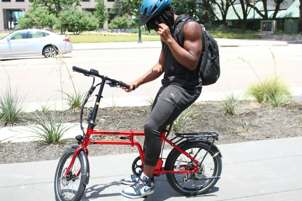 Why More Travelers Are Choosing Folding Ebikes for City Tours a man is sitting on a bicycle