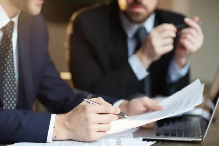 man holding pen and paper in his hands