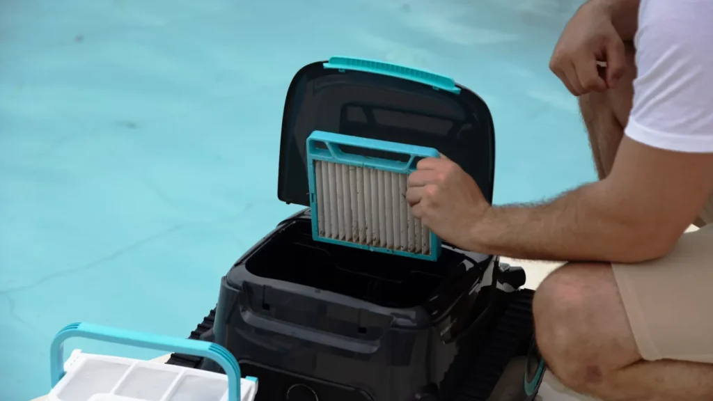 Robot Pool Cleaner Tips: How to Clean a House Pool Easily man is cleaning the filter of pool