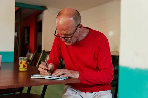 Proven Strategies to Master Business and Company Debt Negotiation man is writing on a notebook