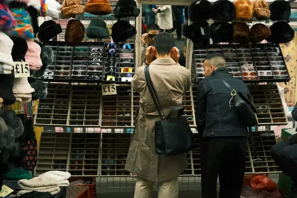 How to Change Your Game in Finding Custom Beanies Men standing in front of Cap stall