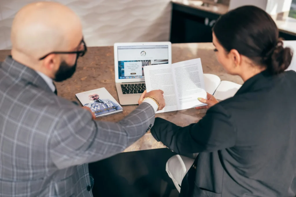 7 Benefits Business Coach Sessions Bring to New Startups a man pointing at a book