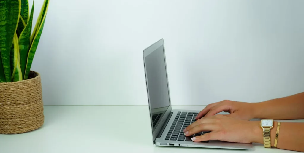 Save Time and Money: Skip Tracing Services for Law Firms Explained person using laptop