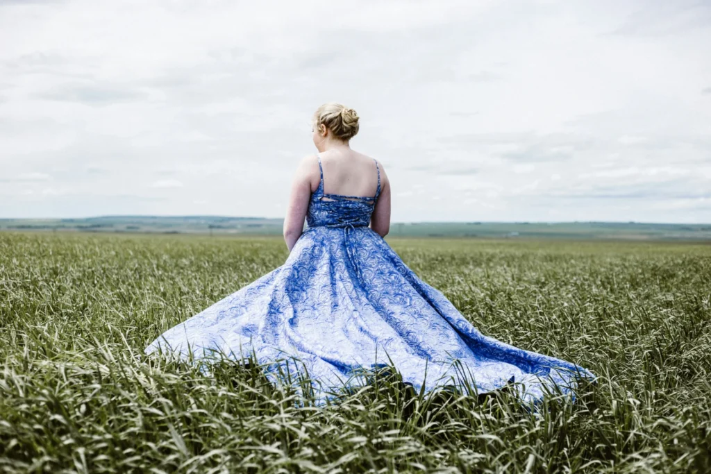 Tips for Selecting the Perfect Plus-Size Dress Woman standing on a green grass field