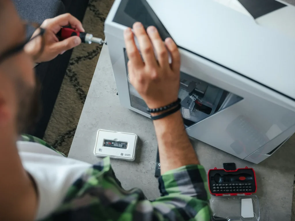 Tips for Choosing Reliable ID Card Printers for Manufacturing Man using using drive on printer machine