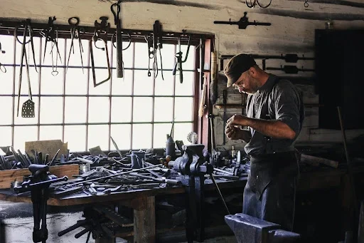 The Essential Guide to Fly Tying Vises a man standing next to table